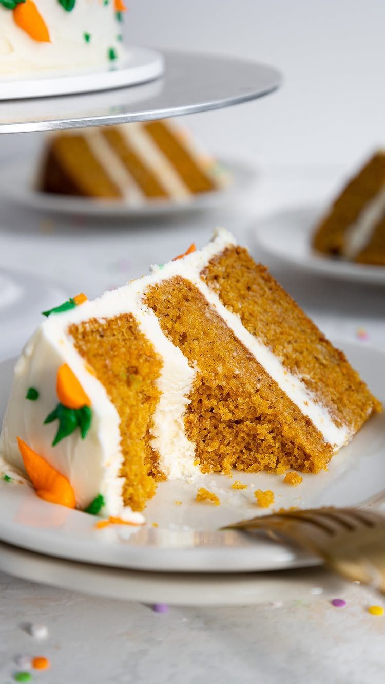 6 Inch Cake Decorating Ideas: 11 Flavors and Finishes to Try 4 Slice of layered carrot cake with white frosting and tiny carrot decorations