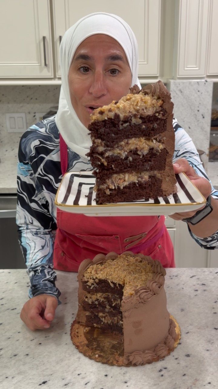 6 Inch Cake Decorating Ideas: 11 Flavors and Finishes to Try 7 Chocolate cake with coconut pecan frosting layers held by a woman in a hijab.