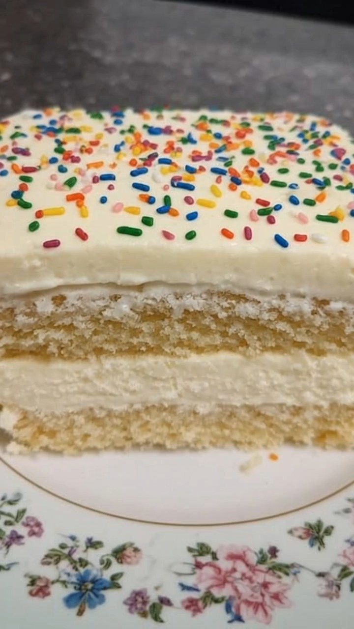 6 Inch Cake Decorating Ideas: 11 Flavors and Finishes to Try 9 Layered sponge cake with white frosting and colorful sprinkles on a floral plate.