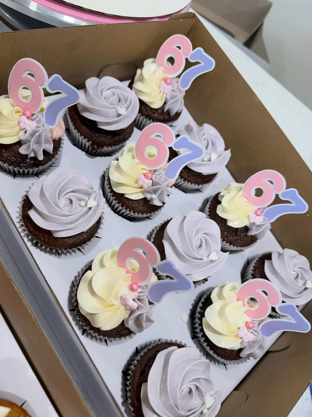 67 Cake Ideas for Birthdays: 14 Designs From Drip to Neon 13 Chocolate cupcakes with purple and yellow frosting and number 67 cake toppers.