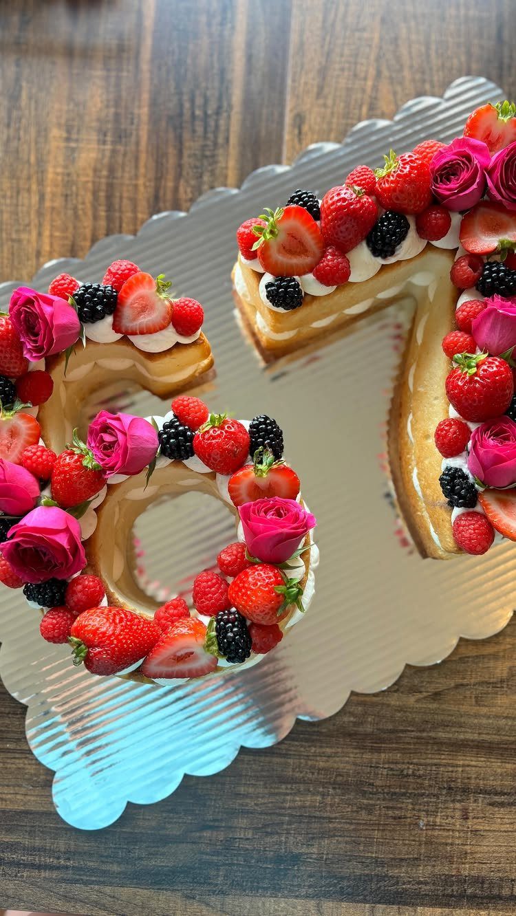 67 Cake Ideas for Birthdays: 14 Designs From Drip to Neon 8 Number 67 cake decorated with fresh berries and pink roses on silver board