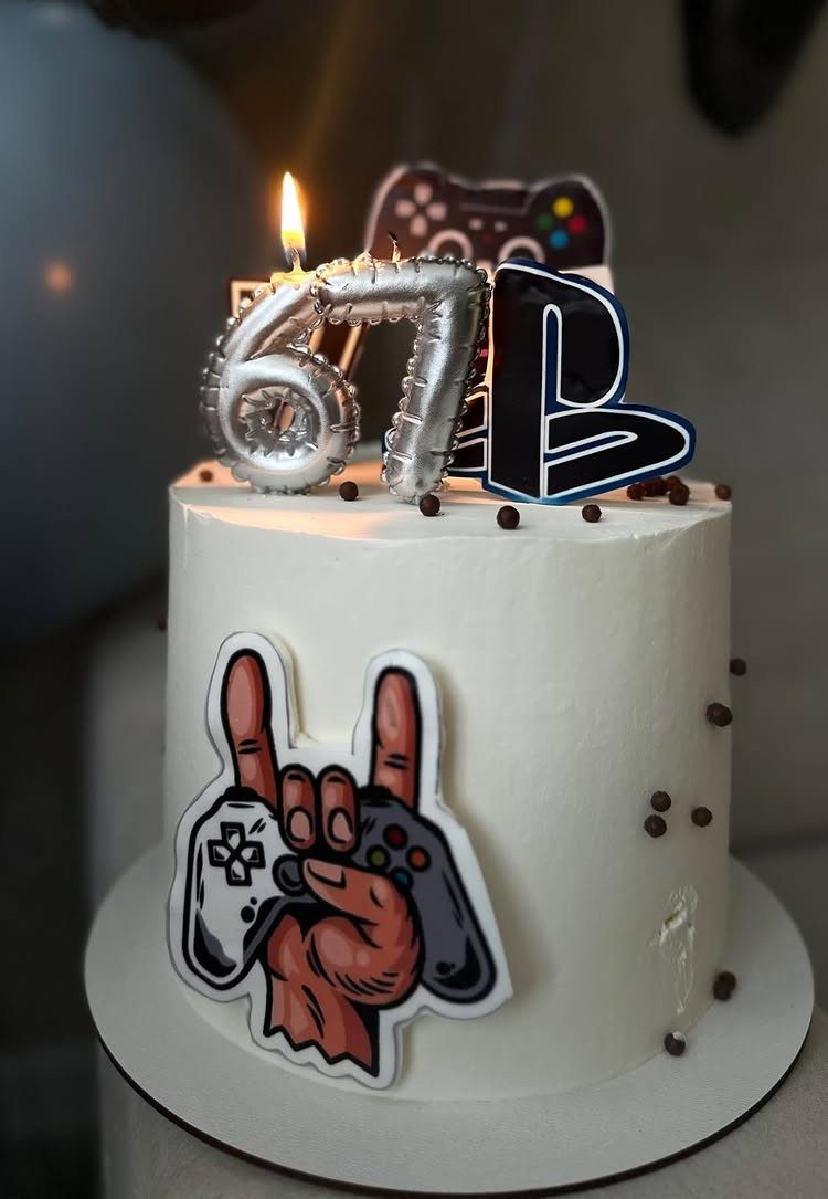 67 Cake Ideas for Birthdays: 14 Designs From Drip to Neon 9 White frosted cake with silver 67 balloons and gaming themed decorations