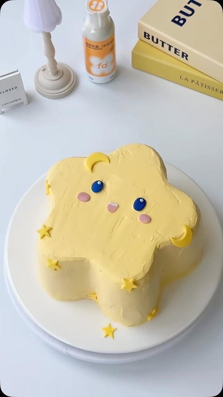 67 Cake Ideas for Birthdays: 14 Designs From Drip to Neon 6 Yellow star-shaped cake with a cute face and small star decorations on white plate