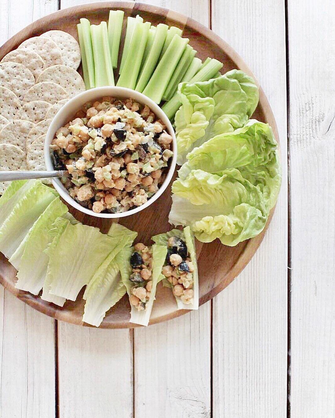 31 Beach Themed Appetizers for Parties, Picnics and Pool Days 6 Chickpea salad in a bowl with lettuce wraps, celery, and crackers on a platter.