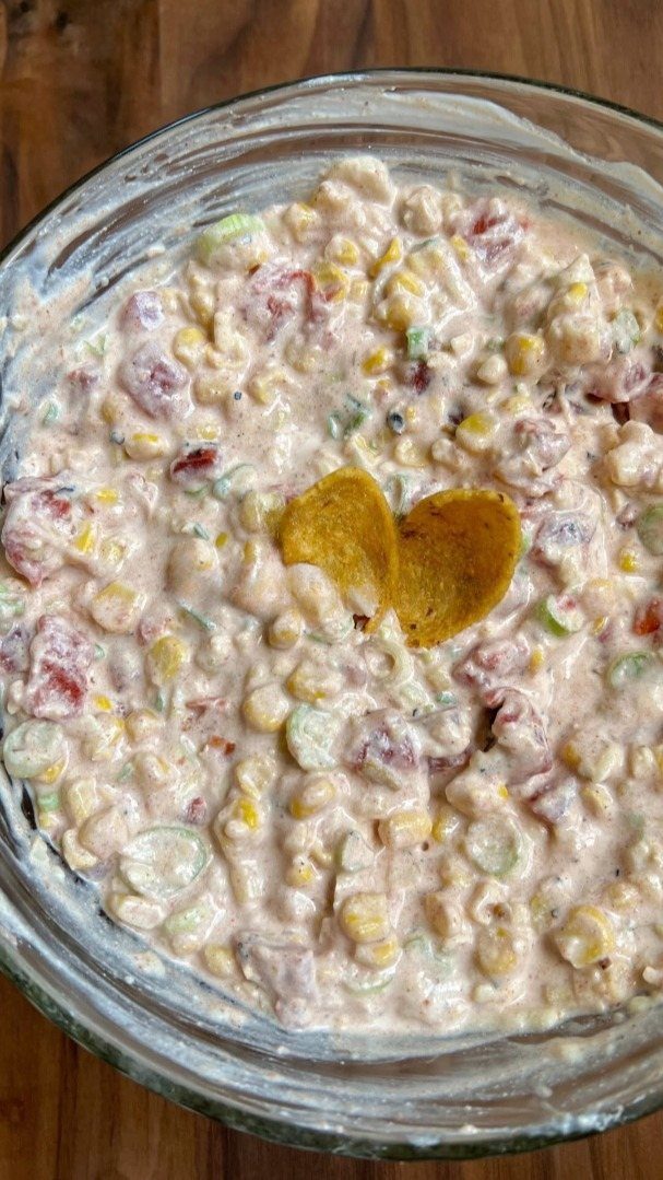 31 Beach Themed Appetizers for Parties, Picnics and Pool Days 19 Creamy corn and pepper dip in a glass bowl with tortilla chips.