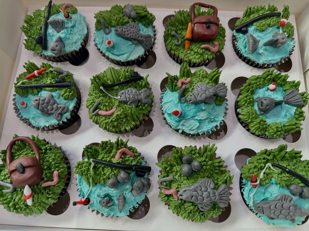 31 Beach Themed Appetizers for Parties, Picnics and Pool Days 20 Fishing themed cupcakes with blue water, green grass, grey fish, and tackle boxes.