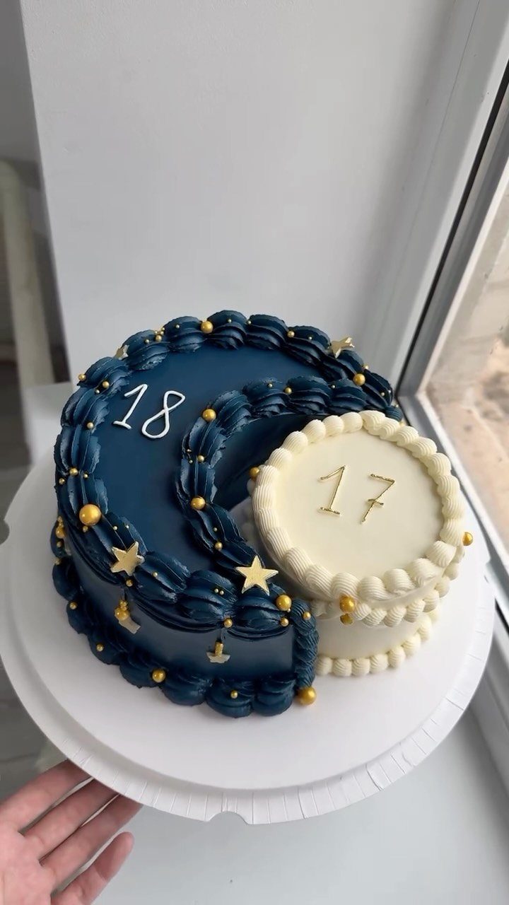 Crescent moon and full moon birthday cake in dark blue and white colors.