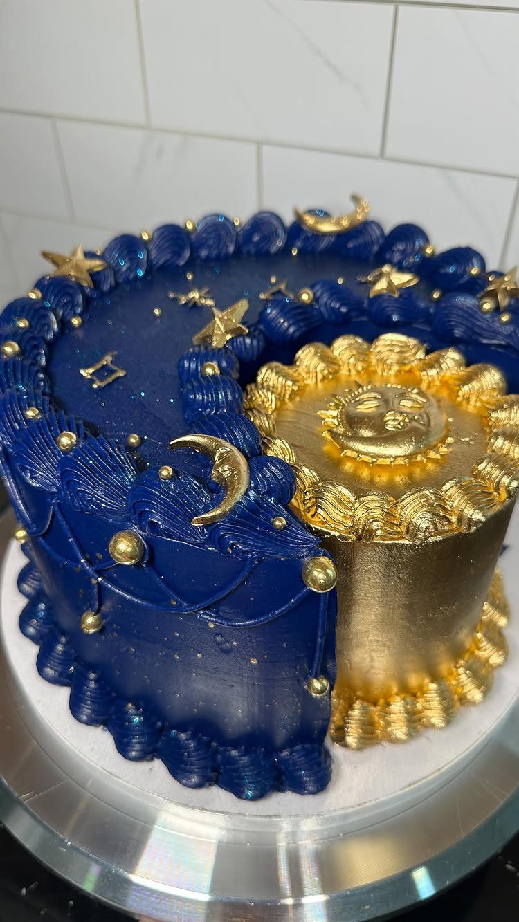 Celestial cake with blue and gold frosting featuring stars and a moon face.
