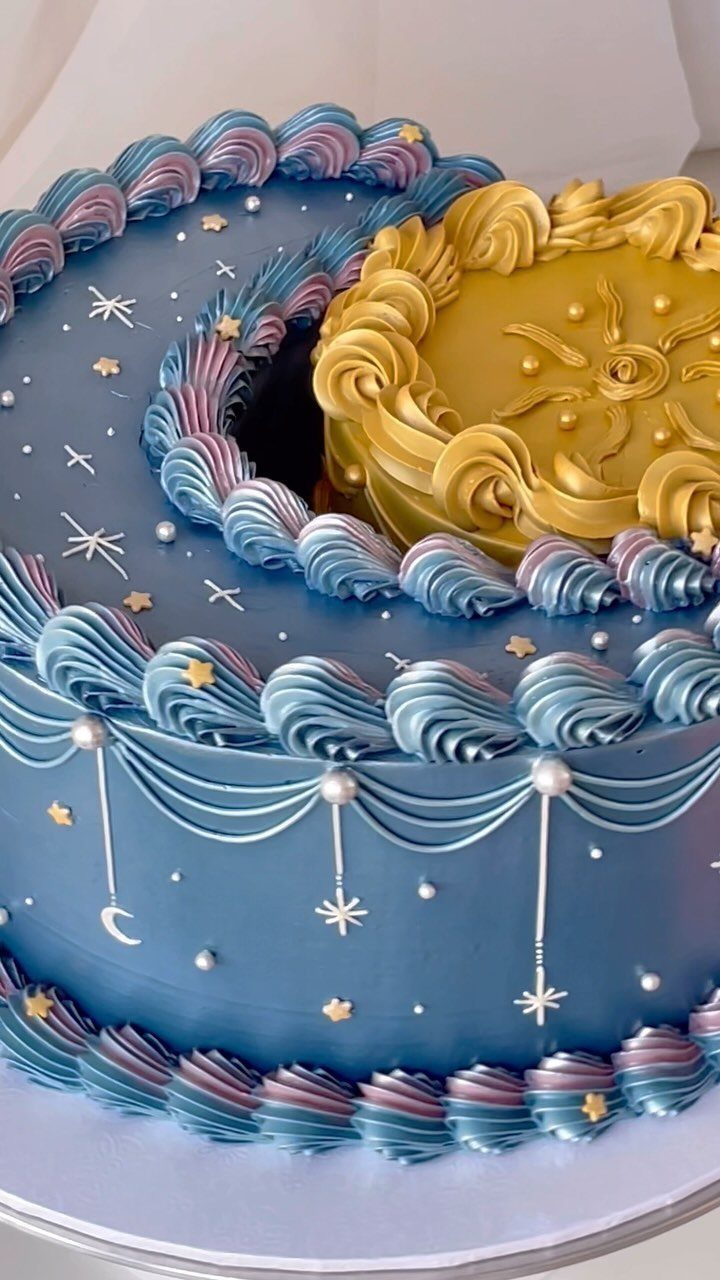 Blue celestial cake with a gold sun cake nestled in a crescent cutout.