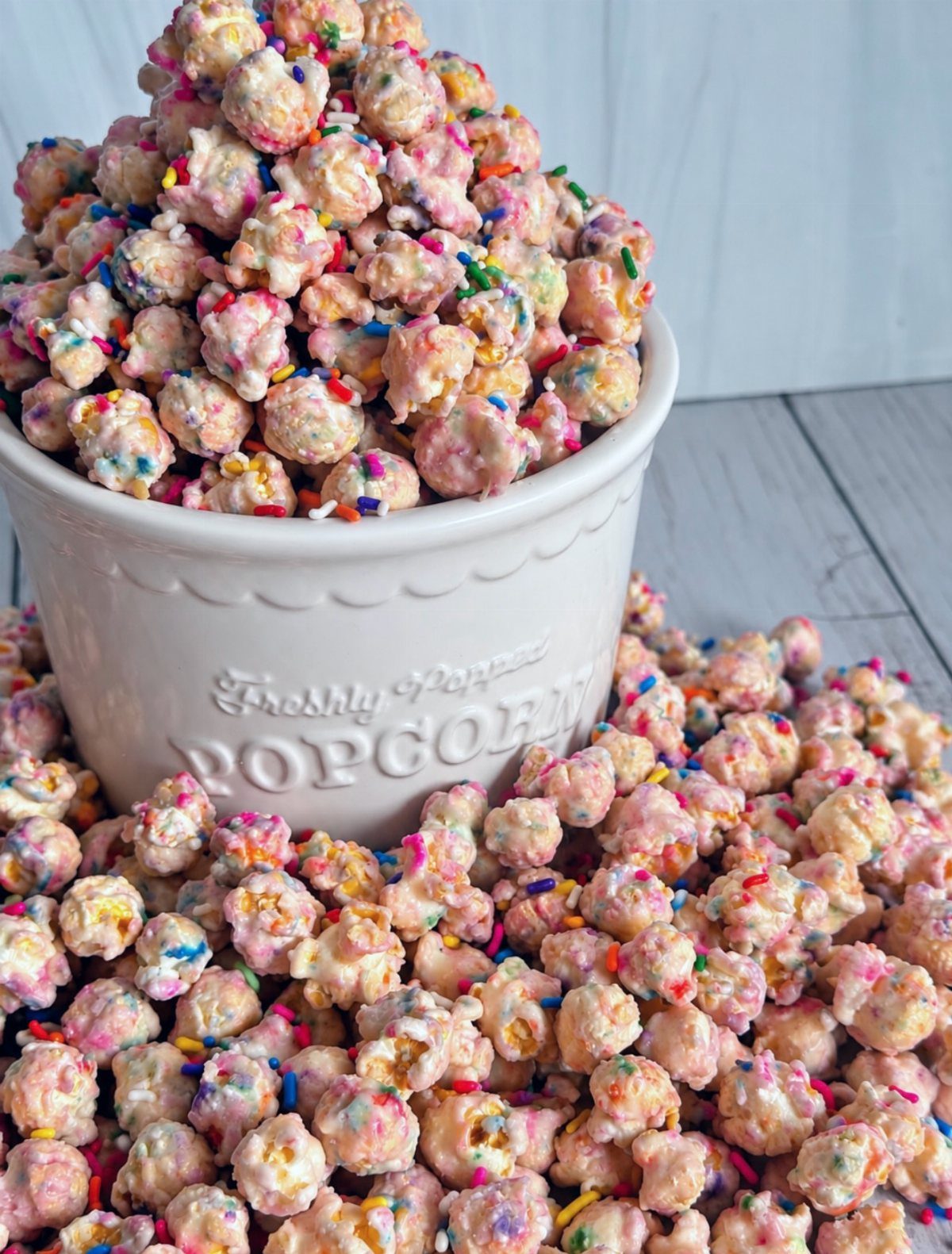 13 Birthday Party Treat Ideas, From Popcorn to Tea Sandwiches 3 Pink and white frosted popcorn with colorful sprinkles in a white ceramic bowl