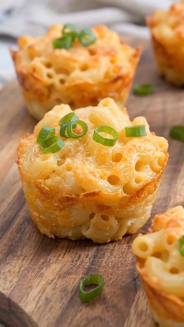 13 Birthday Party Treat Ideas, From Popcorn to Tea Sandwiches 12 Mac and cheese bites topped with green onions on a wooden board.