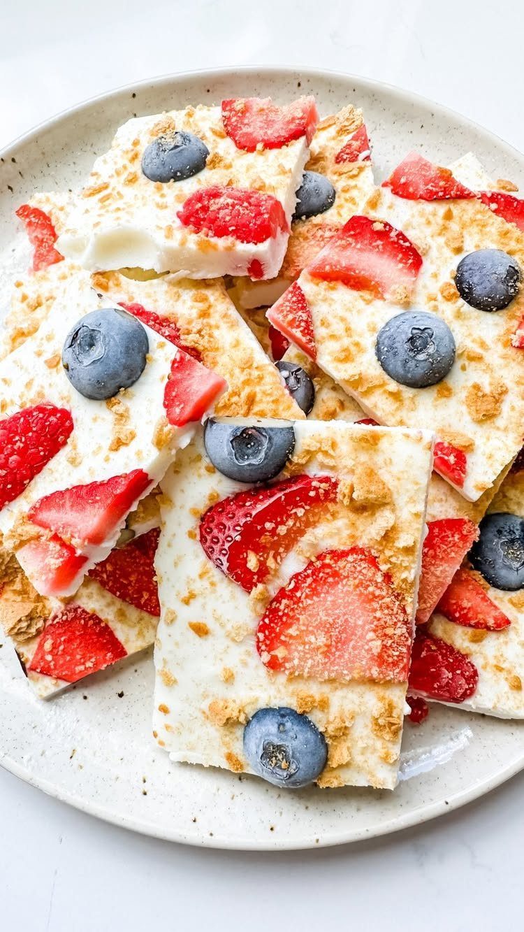 13 Birthday Party Treat Ideas, From Popcorn to Tea Sandwiches 9 White chocolate bark with fresh strawberries and blueberries on a white plate