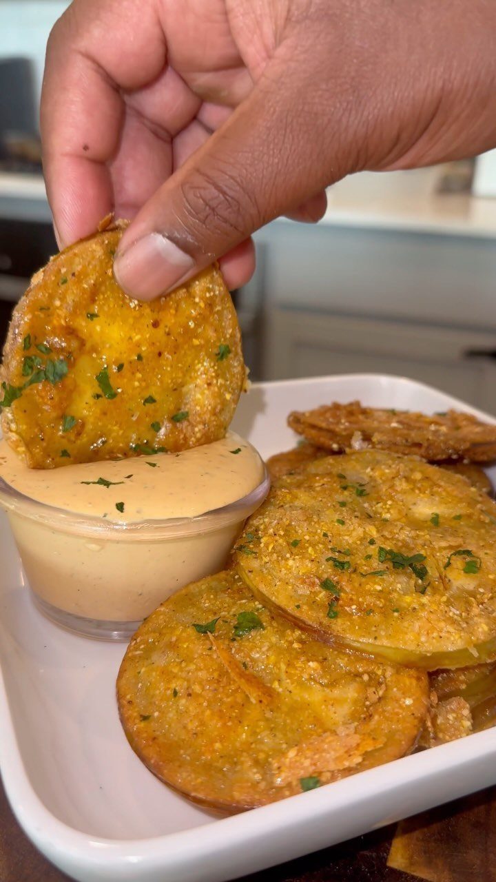 25 Black People Finger Foods 5 Fried green tomato slices with dipping sauce and parsley garnish in a white dish.