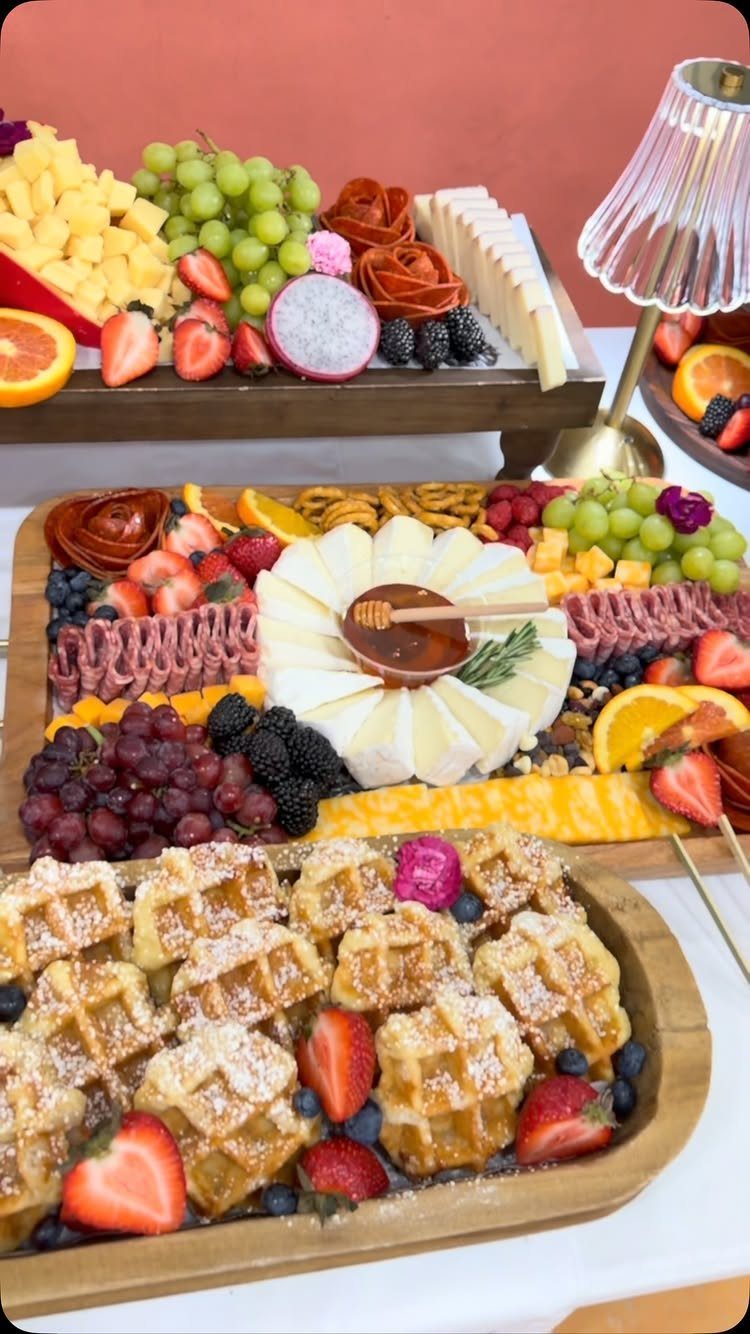 Charcuterie Board Table Ideas: 38 Grazing Tables and Platters 7 Waffles with berries and a cheese and meat charcuterie board on wooden platters.