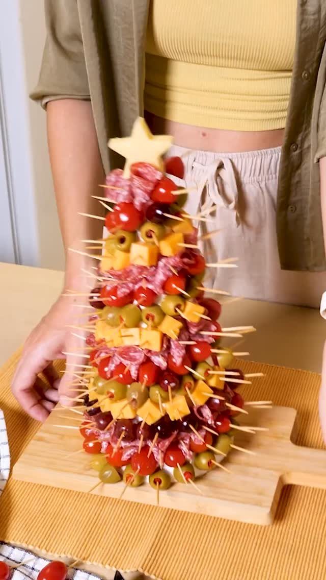 Charcuterie Board Table Ideas: 38 Grazing Tables and Platters 38 Christmas tree charcuterie arrangement with cheese, olives, and salami on a wooden board.