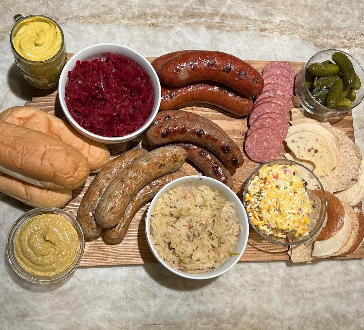 Charcuterie Board Table Ideas: 38 Grazing Tables and Platters 5 Grilled sausages and salami on a wooden board with various side dishes and mustard.