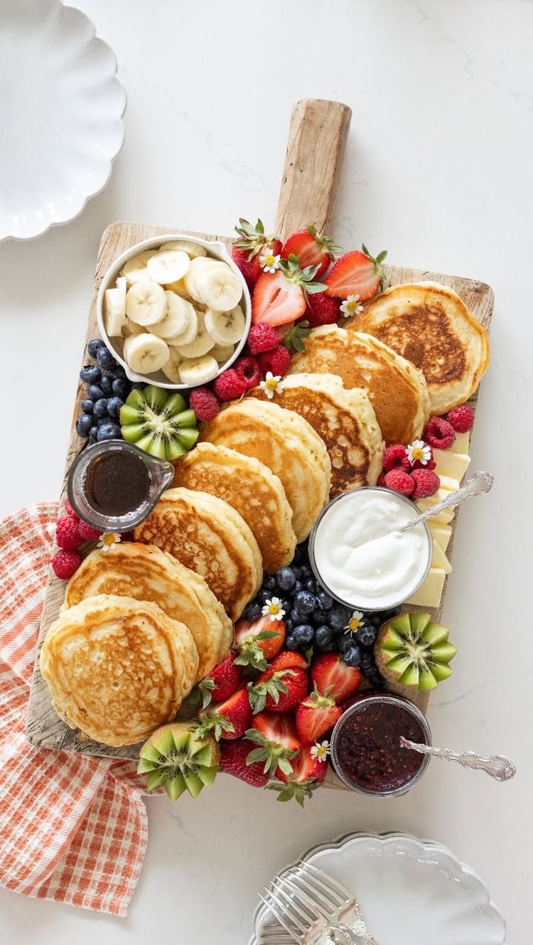 Charcuterie Board Table Ideas: 38 Grazing Tables and Platters 23 Pancake breakfast board with fresh berries, sliced kiwi, bananas, syrup, and yogurt.