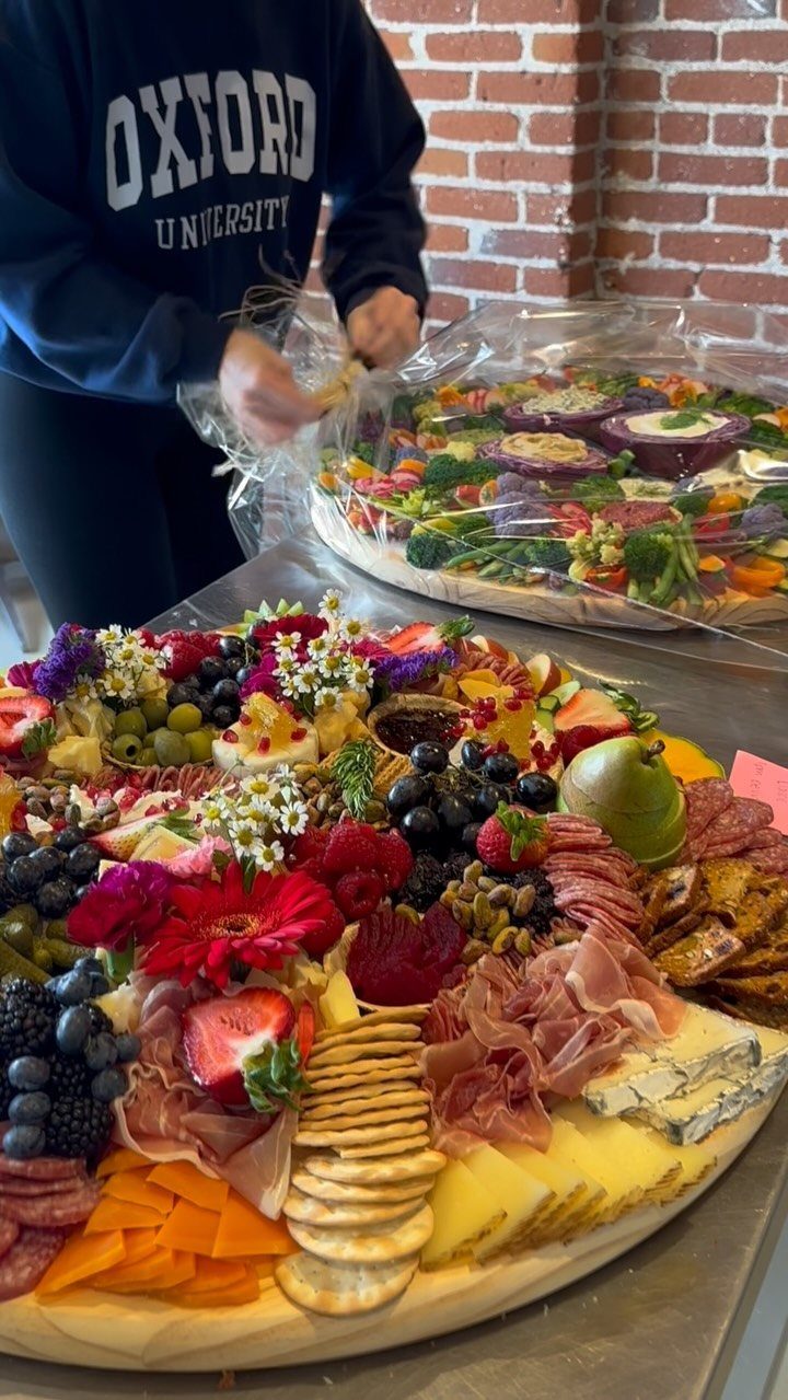 Charcuterie Board Table Ideas: 38 Grazing Tables and Platters 11 Large wooden charcuterie board with meats, cheeses, fresh berries, and colorful edible flowers.