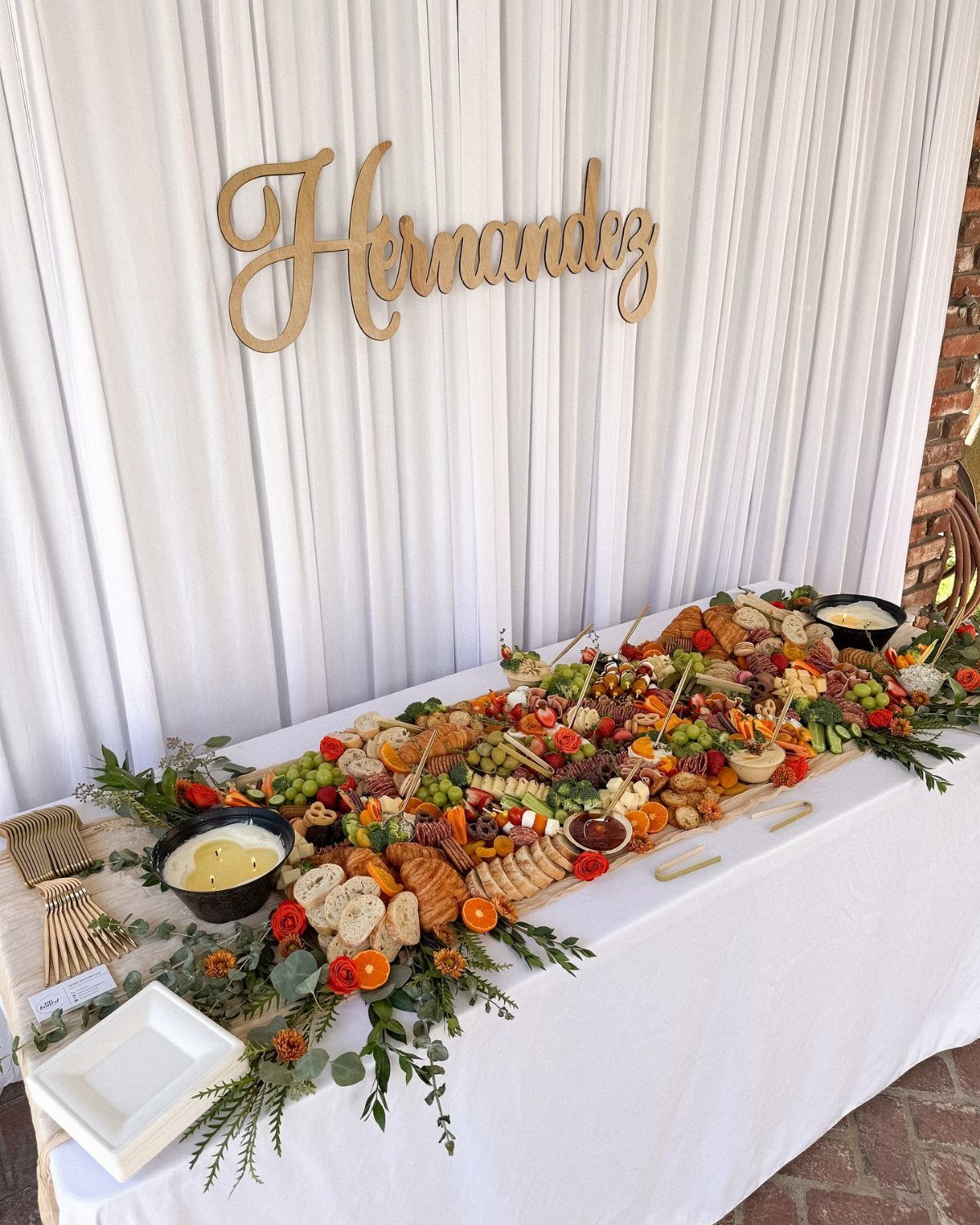 Charcuterie Board Table Ideas: 38 Grazing Tables and Platters 3 Wedding grazing table with meats and cheeses under a gold Hernandez name sign.