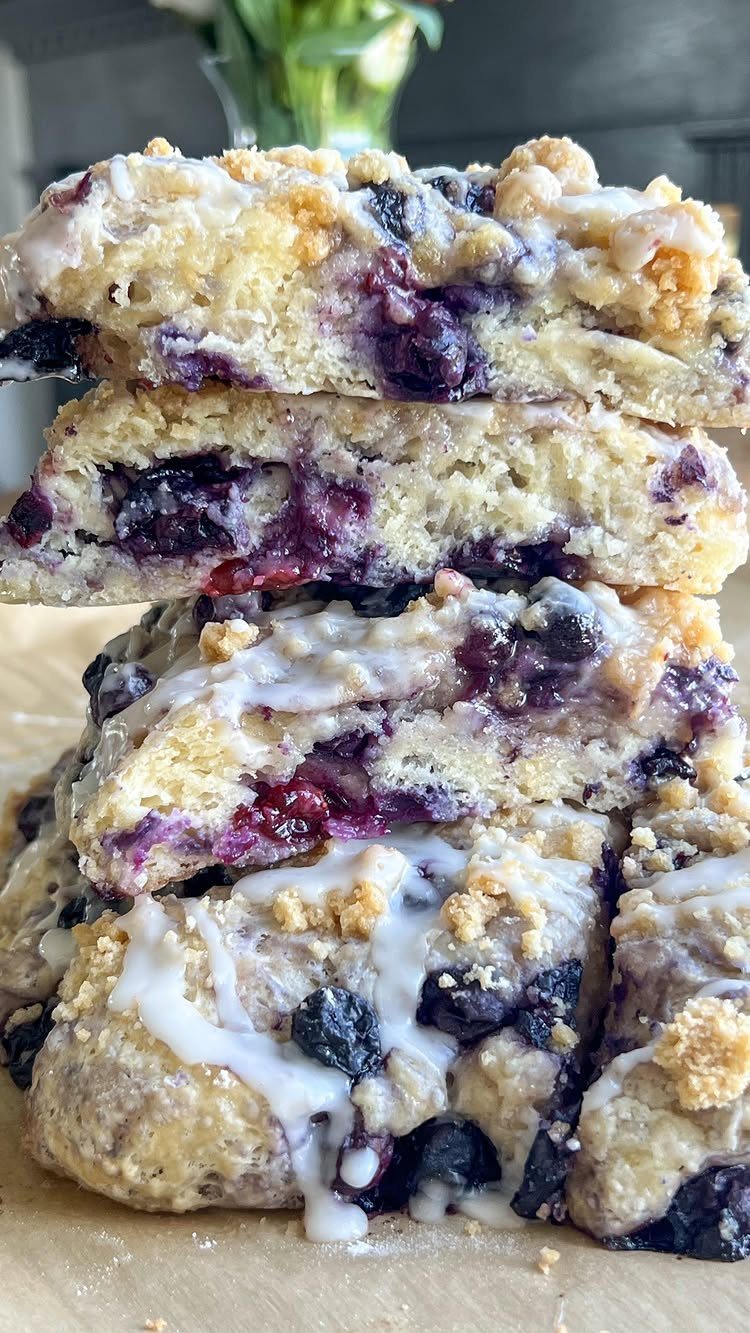 24 Desserts to Make with Blueberries, Cobbler to Cheesecake 18 Stacked blueberry dessert bars with a crumbly topping and white icing drizzle.