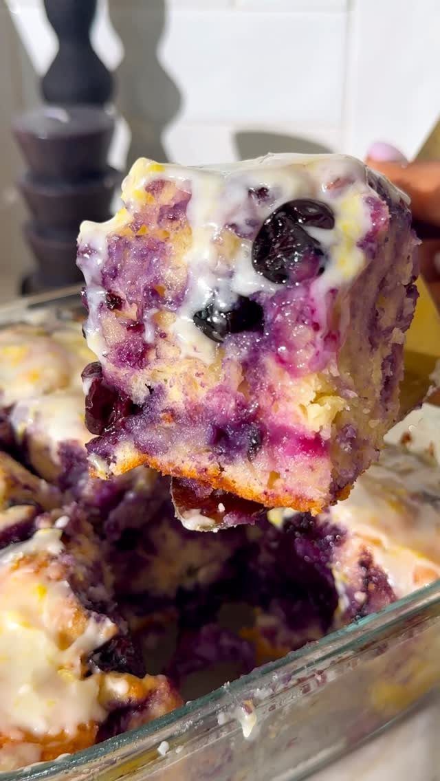 24 Desserts to Make with Blueberries, Cobbler to Cheesecake 24 Piece of blueberry cake with white glaze held above a glass baking dish.