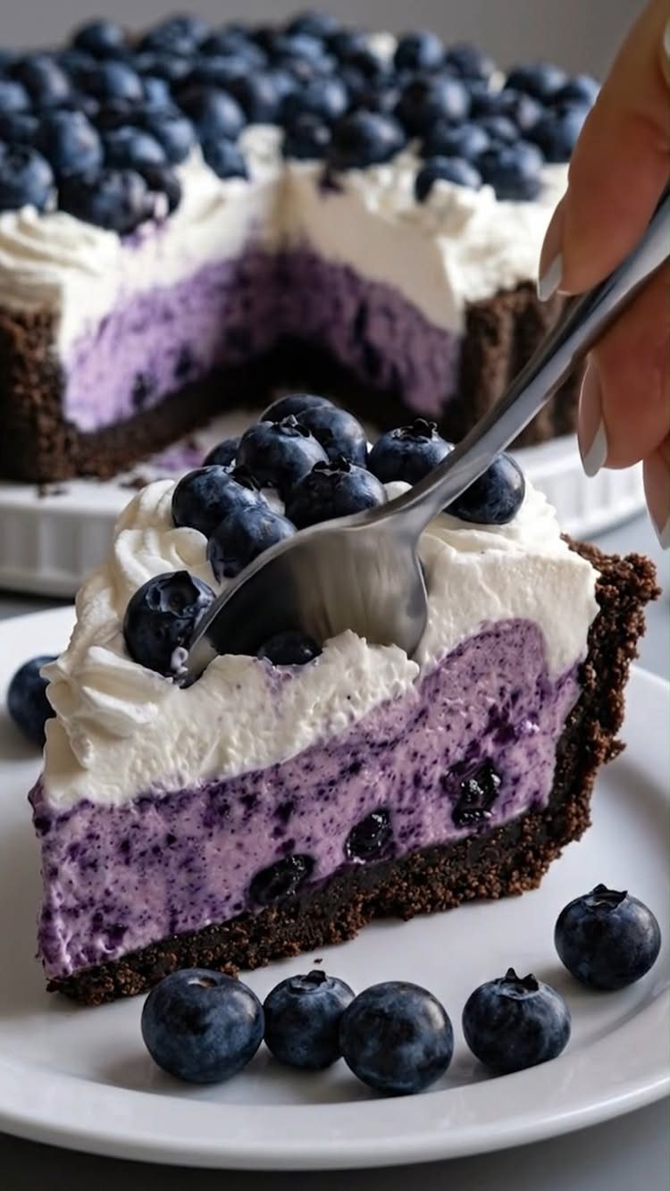 24 Desserts to Make with Blueberries, Cobbler to Cheesecake 12 Blueberry cream pie slice with whipped topping and fresh blueberries on white plate.