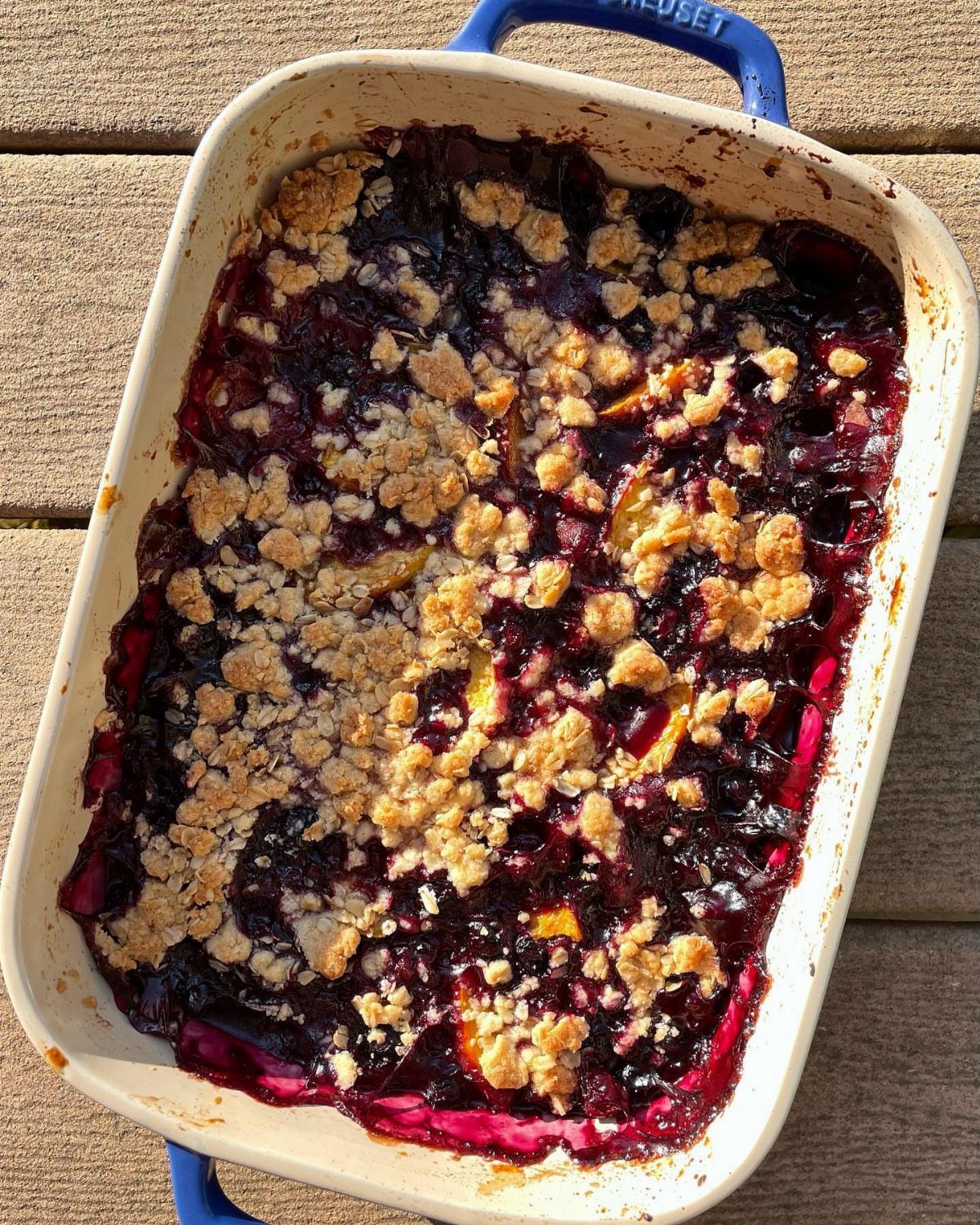 24 Desserts to Make with Blueberries, Cobbler to Cheesecake 23 Blueberry rhubarb crisp with golden crumble topping in a white baking dish.