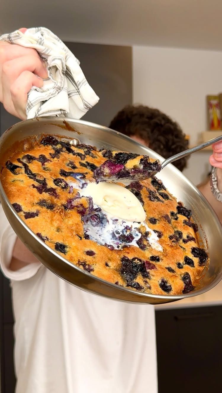 24 Desserts to Make with Blueberries, Cobbler to Cheesecake 13 Baked blueberry cobbler in a metal pan with a scoop of melting cream.