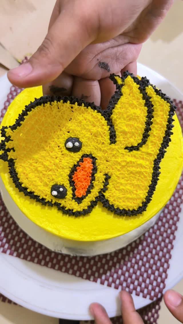 12 Duck Cakes Ideas for Birthdays, From Buttercream to Giant 2 Yellow buttercream cake decorated as a cute duck with black frosting outlines.