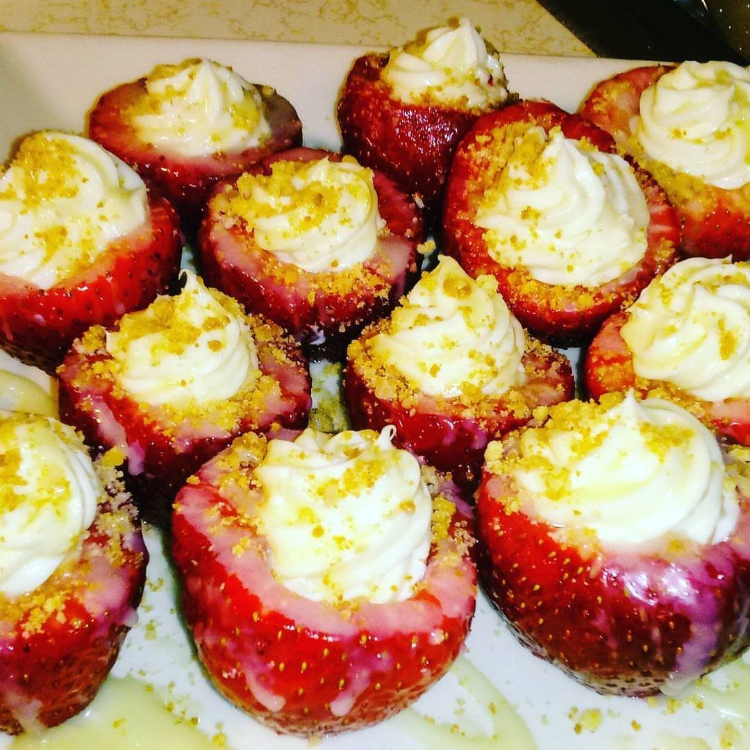 27 Easy Sweet Treats No Bake Ideas, From Fudge to Eton Mess 17 Cheesecake stuffed strawberries with white cream filling and graham cracker crumbs on a platter.