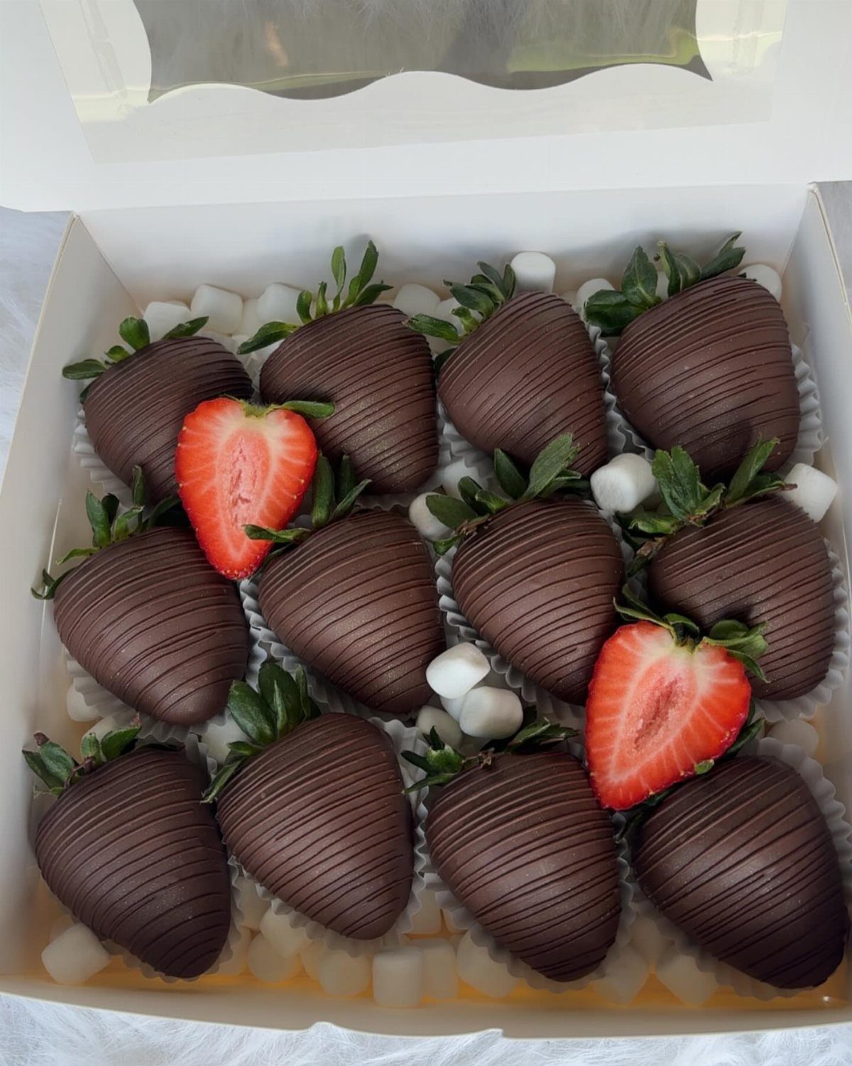 27 Easy Sweet Treats No Bake Ideas, From Fudge to Eton Mess 11 Chocolate-covered strawberries with chocolate drizzle and marshmallows in a white gift box.
