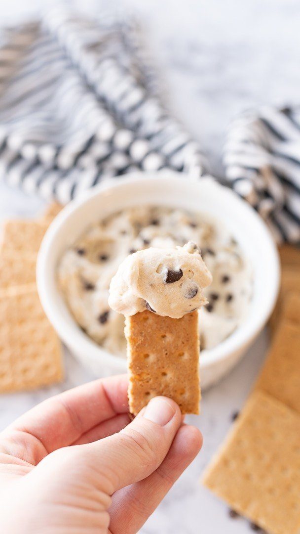 27 Easy Sweet Treats No Bake Ideas, From Fudge to Eton Mess 8 Graham cracker dipped in chocolate chip cookie dough dip in a white bowl.