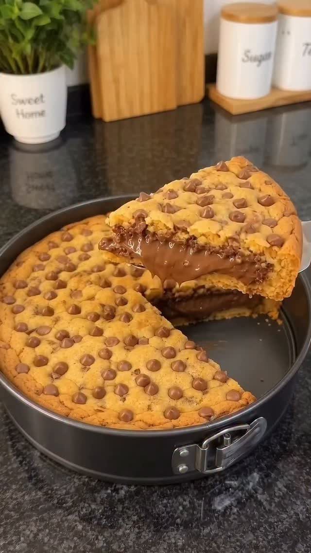 Chocolate chip cookie cake with melted chocolate center in a springform pan.