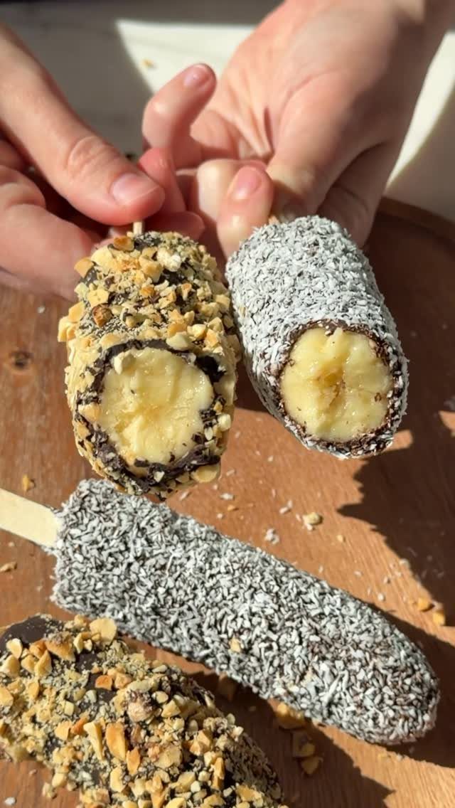 Chocolate covered frozen banana pops coated in crushed nuts and shredded coconut.