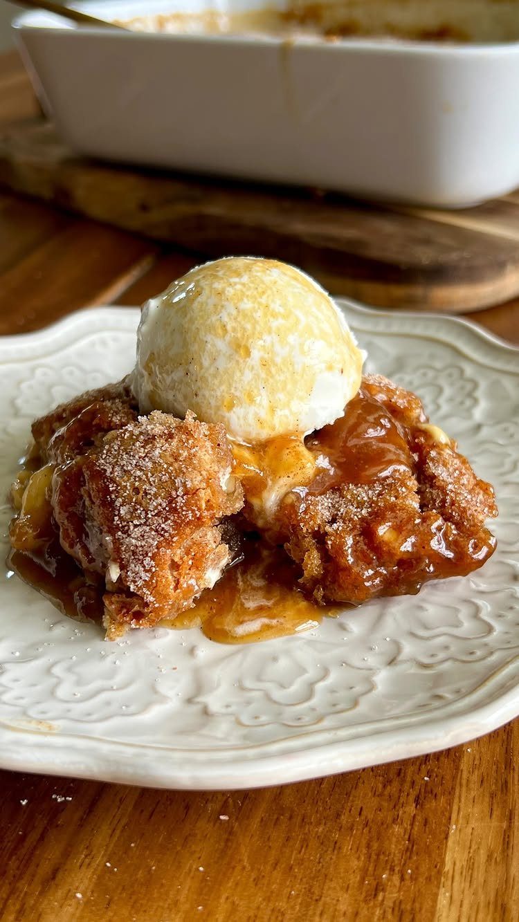 Vanilla ice cream on a warm cinnamon fruit cobbler with caramel sauce.