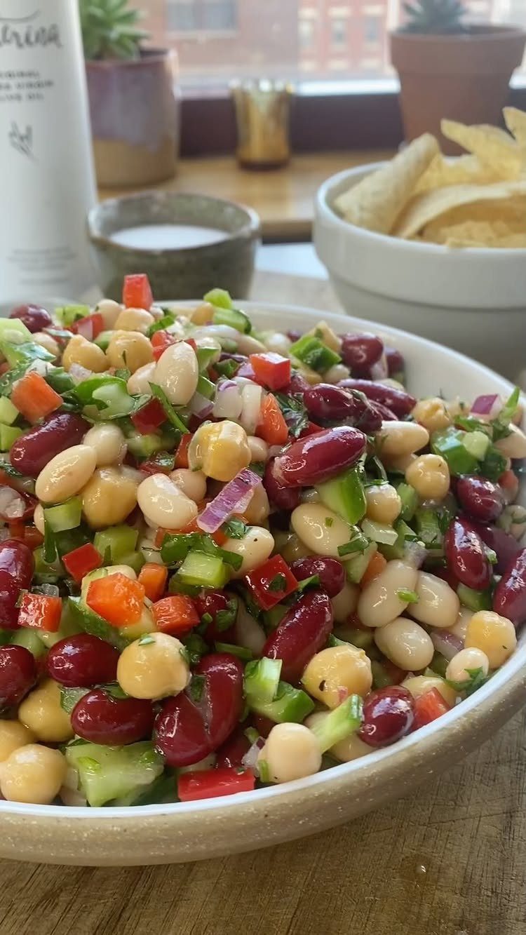 Bean salad with kidney beans, white beans, cucumbers, and peppers in a bowl.