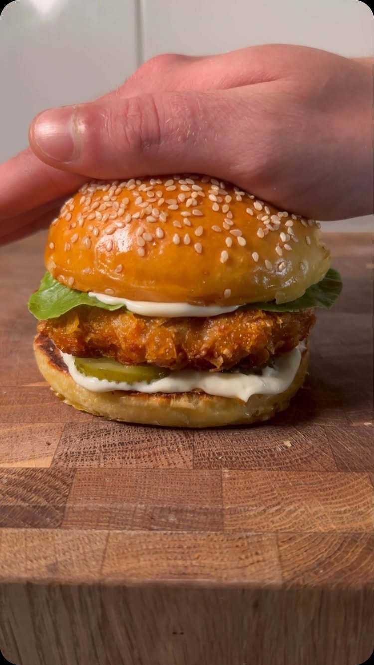 40 Food Lunch Recipes You Can Make in Minutes 34 Fried chicken burger with sesame bun and pickles on a wooden board.