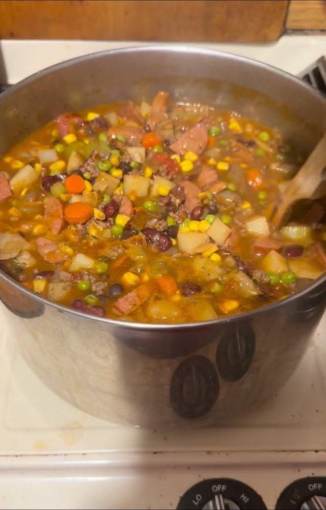 40 Food Lunch Recipes You Can Make in Minutes 27 Hearty meat and vegetable stew with potatoes and corn in a metal pot.