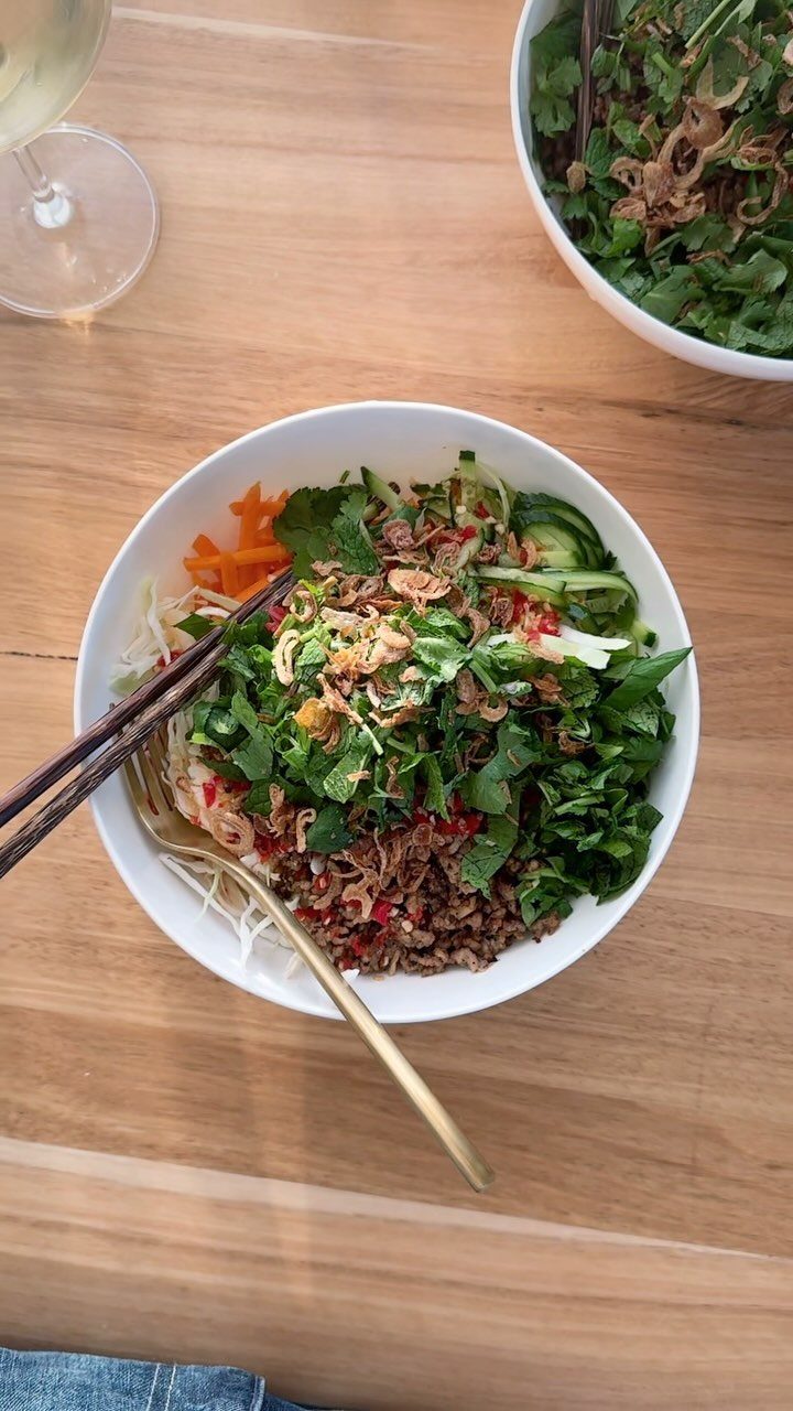 40 Food Lunch Recipes You Can Make in Minutes 11 Pork noodle salad with fresh herbs and vegetables in a white bowl.