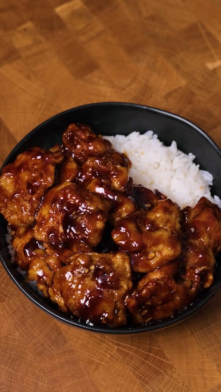 40 Food Lunch Recipes You Can Make in Minutes 29 Glazed fried chicken and white rice in a black bowl on wood.