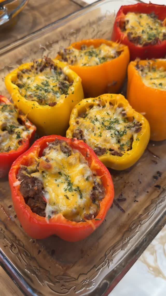 40 Food Lunch Recipes You Can Make in Minutes 25 Stuffed red, yellow, and orange bell peppers with melted cheese in a glass dish.