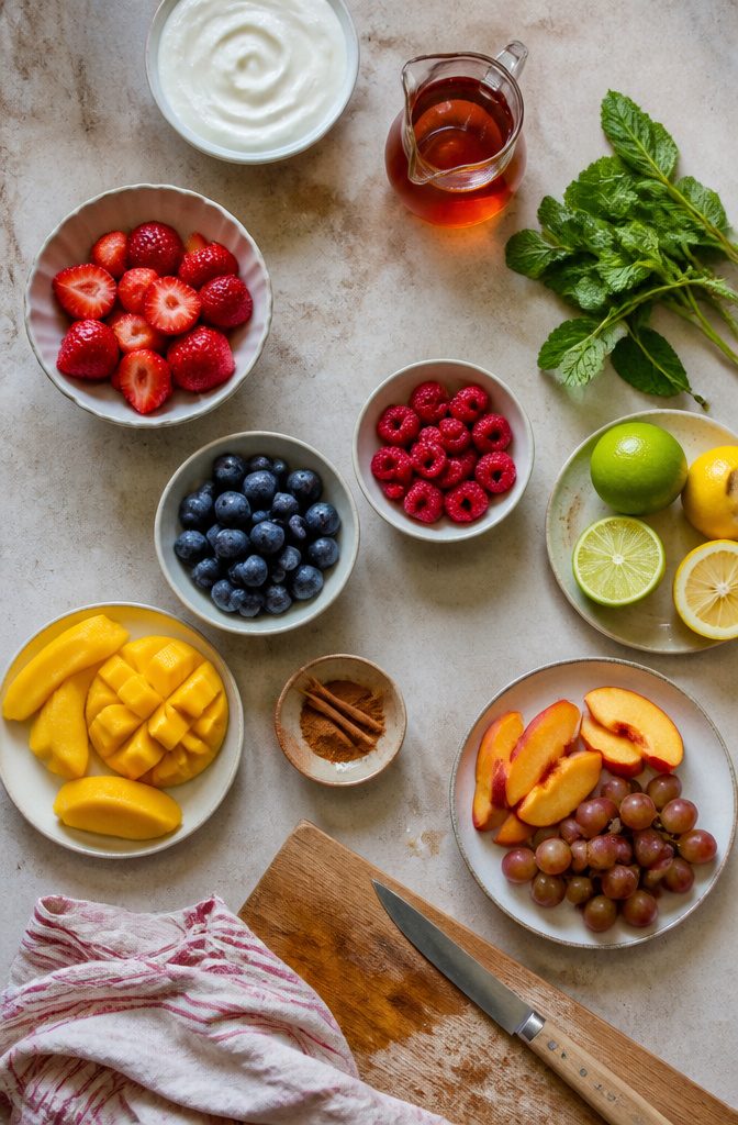 Fresh mint citrus zest spices and fruit arranged as yogurt recipe add-ins