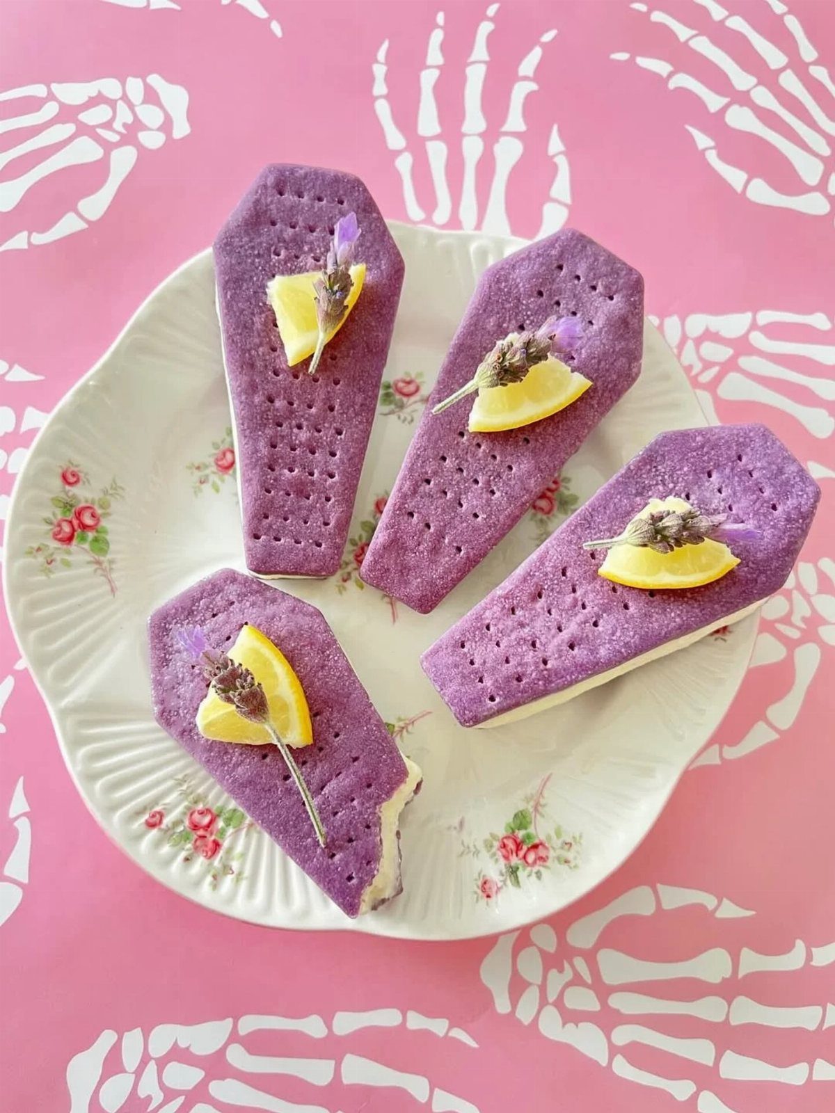 Fun Shaped Cookies: 35 Cut-Out Cookie Recipes to Decorate 26 Purple coffin-shaped cookies with lemon and lavender on a floral plate and pink background