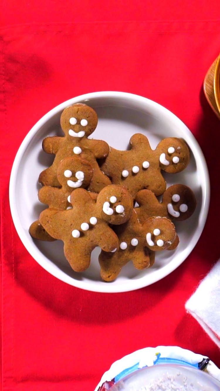 Fun Shaped Cookies: 35 Cut-Out Cookie Recipes to Decorate 9 Gingerbread man cookies with white icing on a white plate over red background