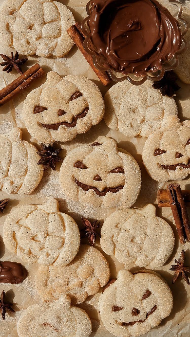 Fun Shaped Cookies: 35 Cut-Out Cookie Recipes to Decorate 10 Pumpkin shaped cookies with cinnamon sugar and chocolate faces with cinnamon sticks.