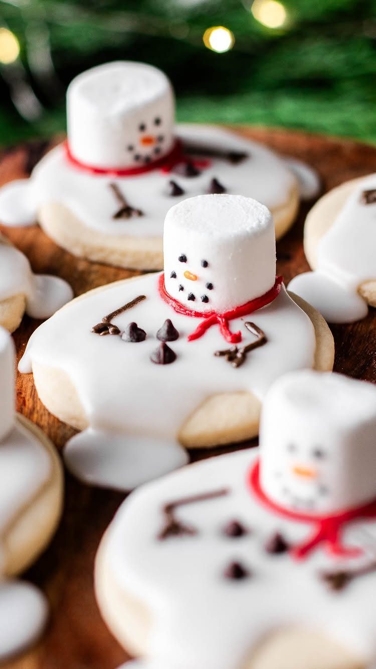 Fun Shaped Cookies: 35 Cut-Out Cookie Recipes to Decorate 21 Snowman shaped sugar cookies with white icing, marshmallow heads, and red scarves.