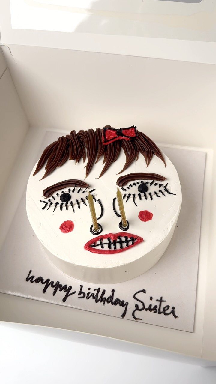 24 Funny Cakes Ideas for Birthdays, From Pizza to Poop Emoji 14 White frosted cake decorated as a woman's face with brown hair and red lips.