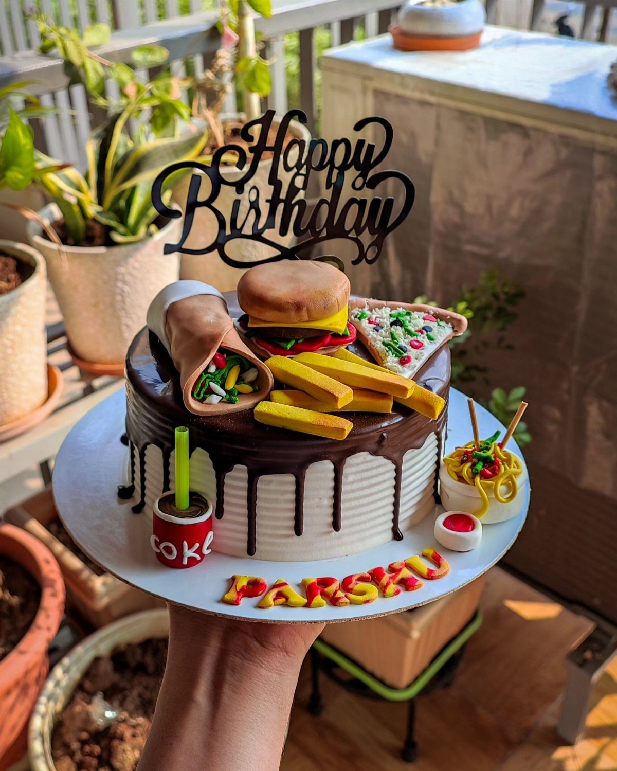 24 Funny Cakes Ideas for Birthdays, From Pizza to Poop Emoji 8 Birthday cake topped with fondant burger, fries, pizza, taco, and noodles on a platter.