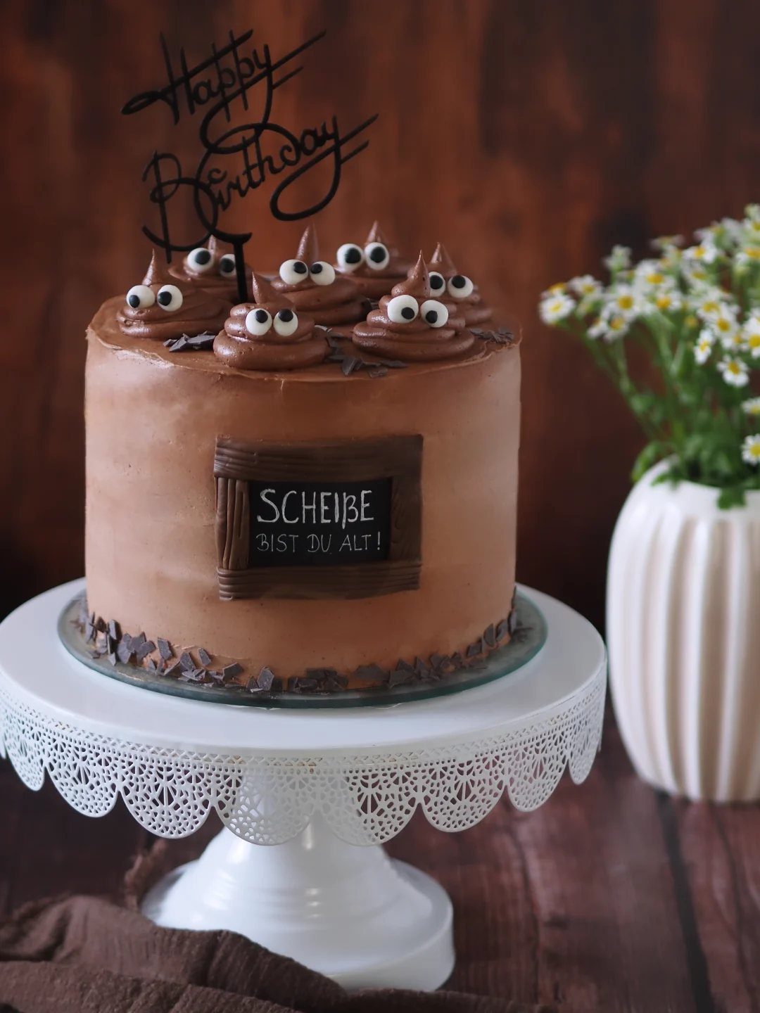 24 Funny Cakes Ideas for Birthdays, From Pizza to Poop Emoji 22 Chocolate cake with poop emoji frosting swirls and a funny German birthday sign.