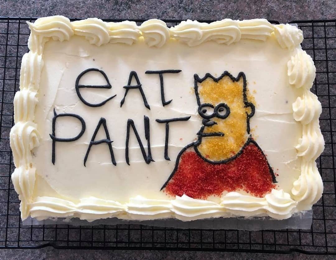 24 Funny Cakes Ideas for Birthdays, From Pizza to Poop Emoji 12 White frosted rectangular cake with a character illustration and text saying Eat Pant